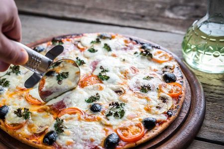 Cooked Pizza on a wooden board.