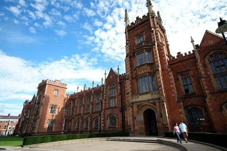 Couple walking around the Queens University Belfast Lanyon Building