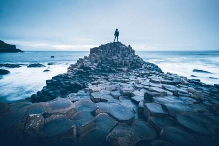 Man on top of Giants Causeway Stones