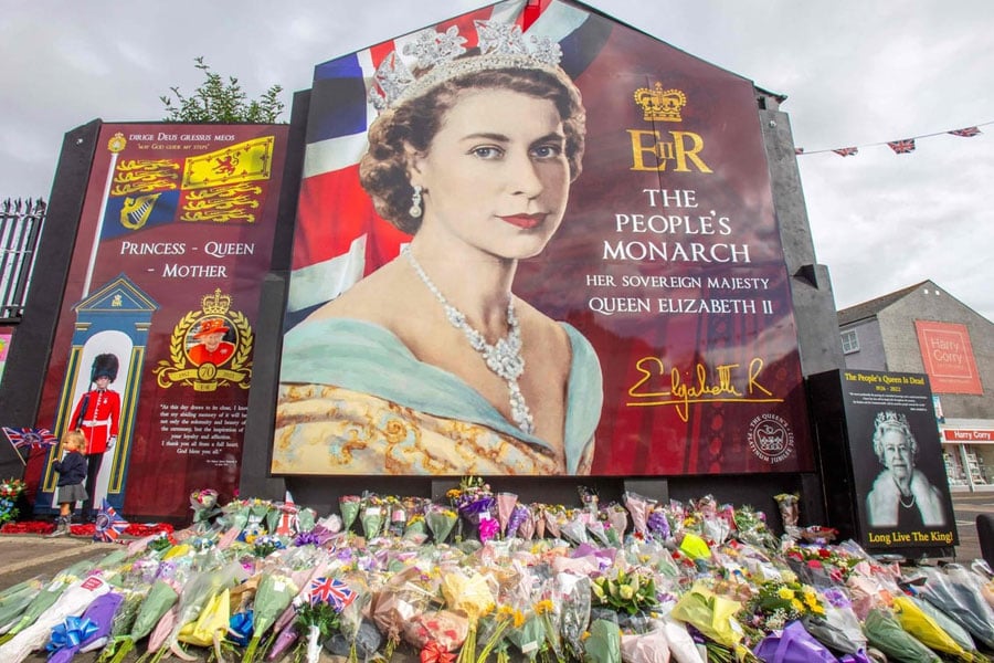 Queen Elizabeth II mural with floral tributes on Shankill Road in Belfast, Northern Ireland
